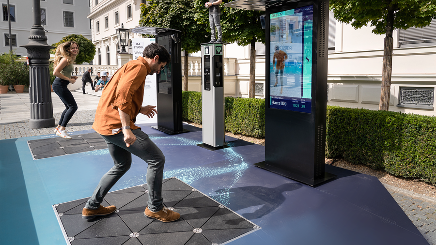 Brand activation participants playing a gamified kinetic energy challenge on an interactive floor 