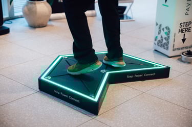 Attendee engaging with Pavegen interactive kinetic floor experience at an expo event 