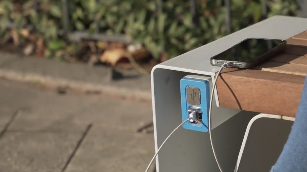 Phone charging bench with phone plugged in